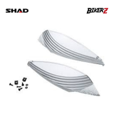 Two motorcycle seat covers with screws on a white background, featuring SHAD and BikerZ logos.