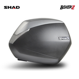 Gray motorcycle storage box with SHAD branding on a white background