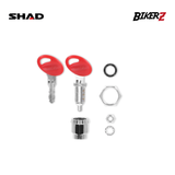 Mechanical parts with red covers and metal components on a white background, featuring SHAD and BikerZ logos.