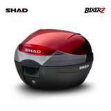 Black and red motorcycle storage box with SHAD branding on a white background