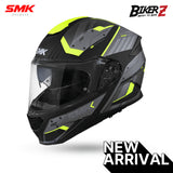A black, gray, and green flip-up motorcycle helmet with 'SMK' branding on the side and 'BikerZ' on the front, featuring a clear visor and a graphic design.