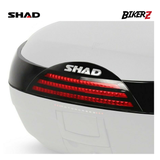 Close-up of a motorcycle tail light with SHAD branding on a white background