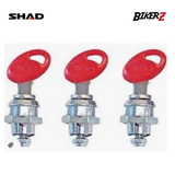 Three metal ignition switches with red keys on a white background, featuring SHAD and BikerZ logos.